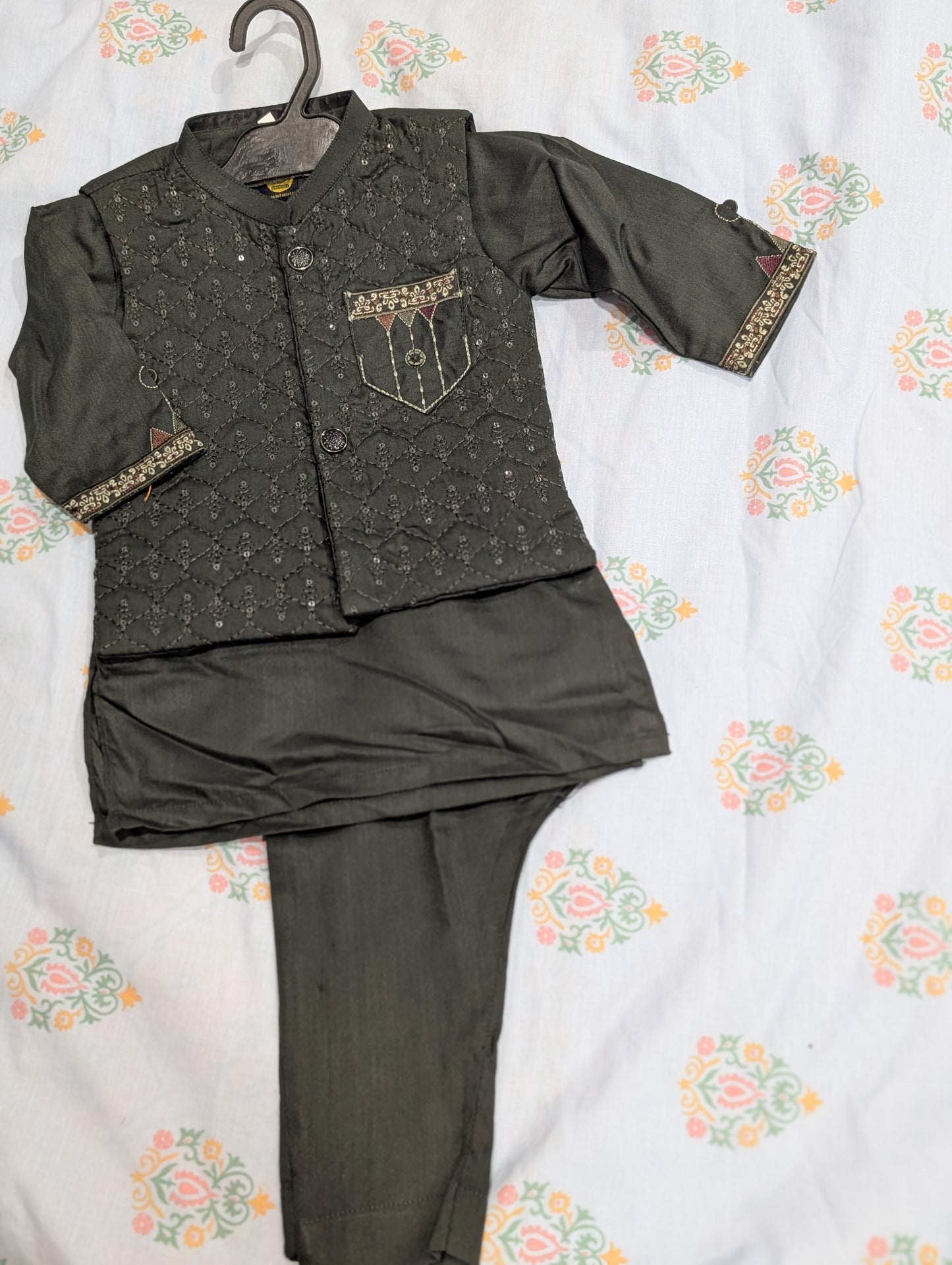 Infant dark green quilted and embellished waistcoat paired with a matching kurta and trousers.