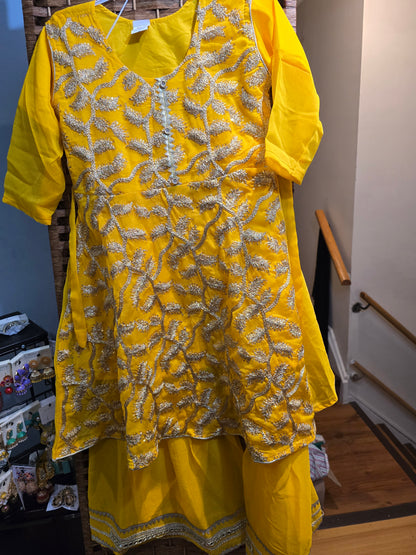 Girl's vibrant yellow traditional ethnic outfit featuring frock intricate gold embroidery across the tunic and matching bottoms gharara.