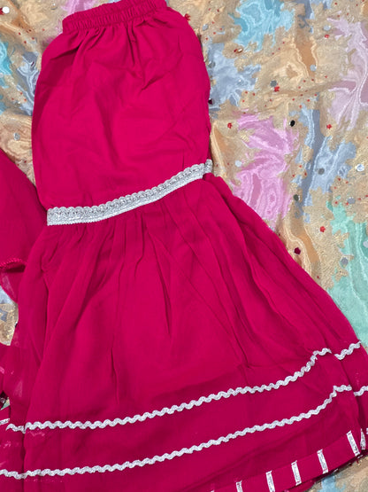 Girls magenta front-open chiffon frock featuring intricate hand embroidery, paired with a matching gharara accented by gotta lace trim and a coordinating chiffon dupatta.