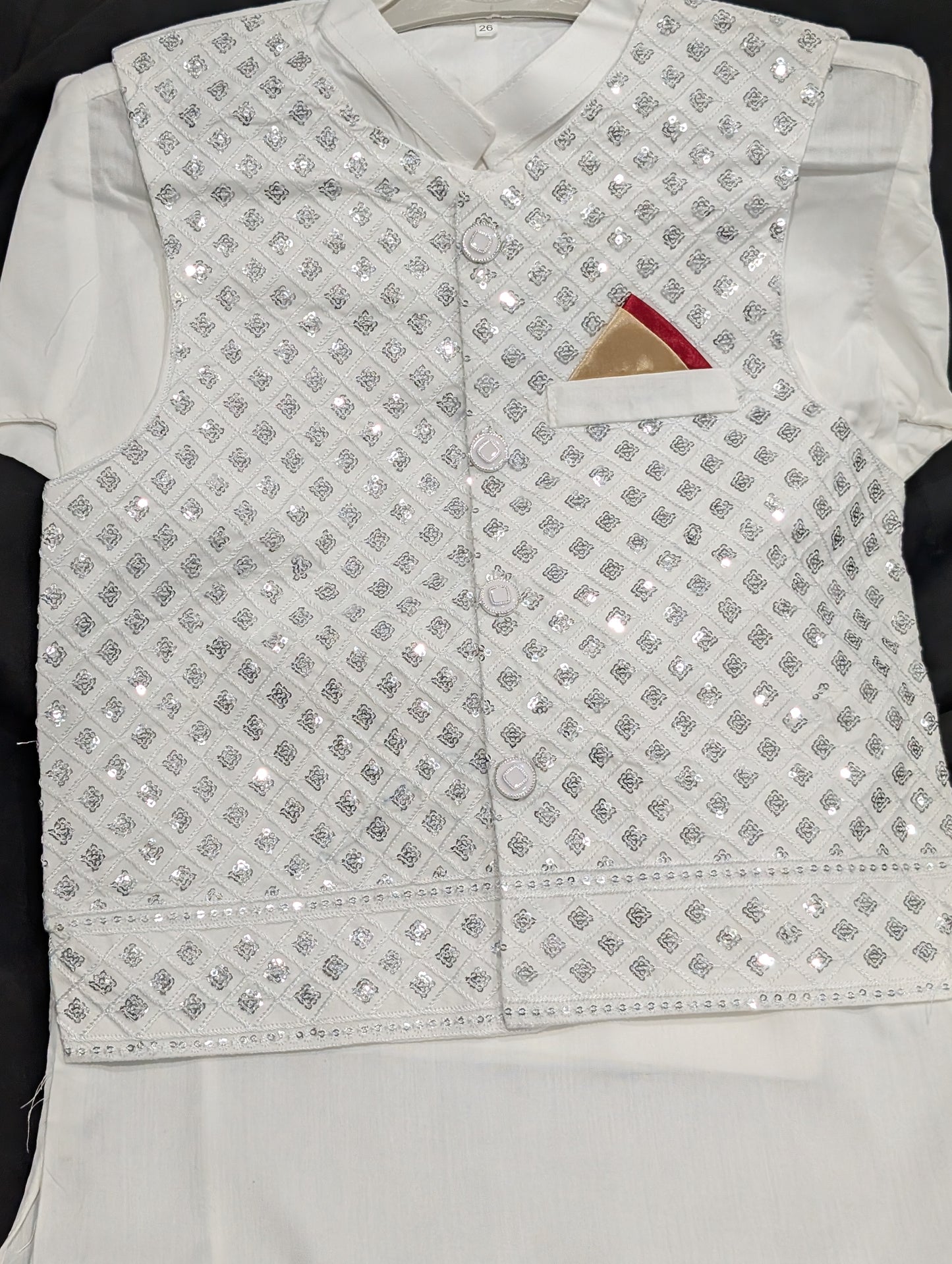 Boys' white kurta with matching pants and a silver embroidered waistcoat.