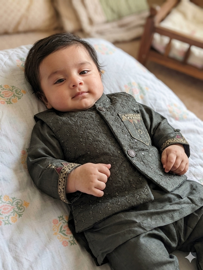 Infant dark green quilted and embellished waistcoat paired with a matching kurta and trousers.