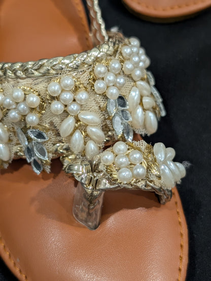 Girls wear mirrors, beaded work, and golden traditional footwear.