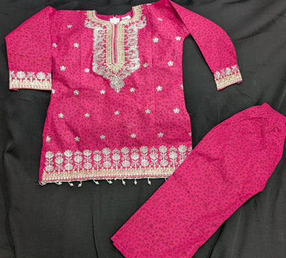 A girls' pink cotton kurta featuring a self-print and embroidery, paired with matching pants and a net dupatta.
