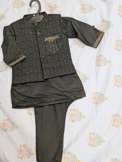 Infant dark green quilted and embellished waistcoat paired with a matching kurta and trousers.