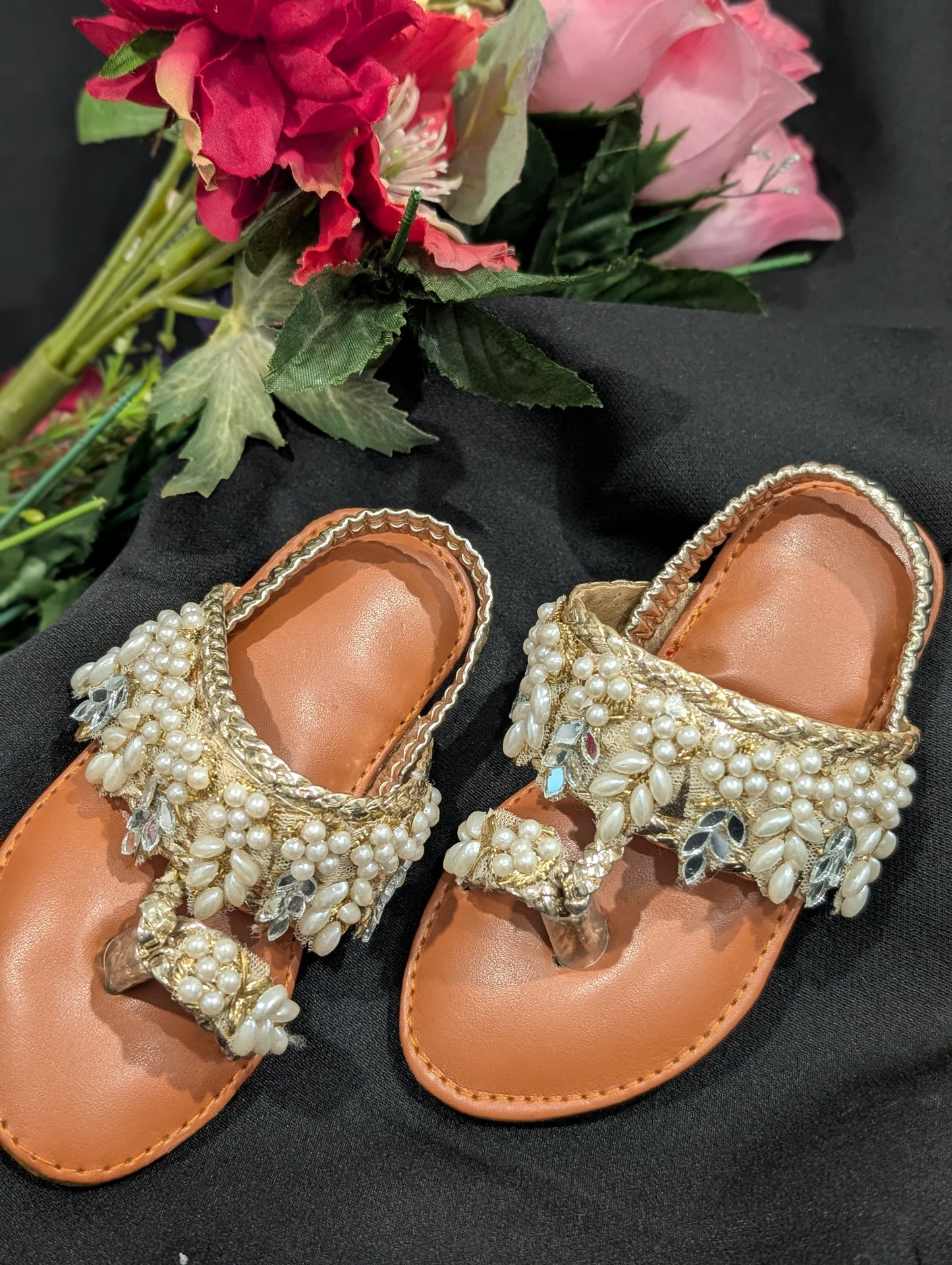 Girls wear mirrors, beaded work, and golden traditional footwear.