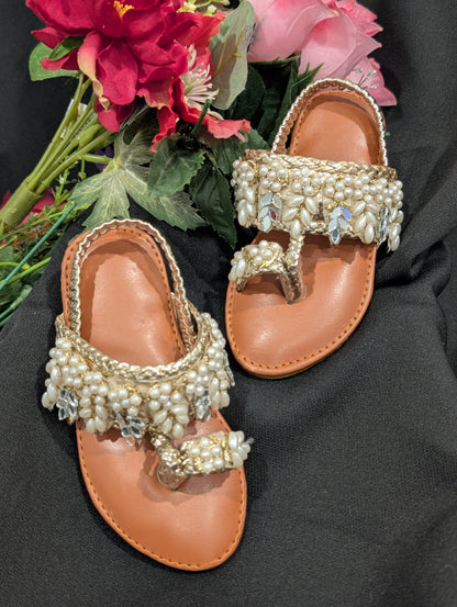 Girls wear mirrors, beaded work, and golden traditional footwear.